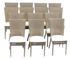 A set of fourteen Lloyd Loom of Spalding wicker dining chairs, each with a tapering high back, overs