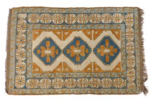 A Turkish Kars rug, blue and rust coloured ground, decorated centrally with three medallions, with m