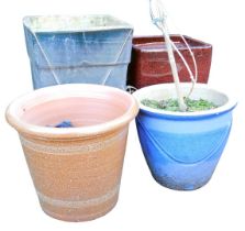 Three garden plant pots, to include a brown glaze example, of tapering cylindrical form, 27cm high.