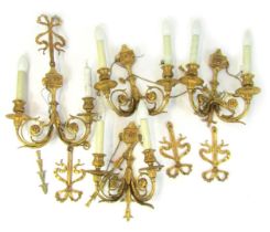 Two pairs of gilt metal Adams style two branch wall lights, each decorated with bow, leaf and floral