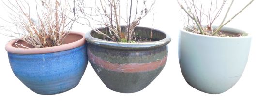 Three garden plant pots, comprising a terracotta blue glazed example, 27cm high, another with green