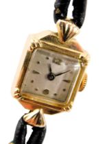 A 9ct gold cased lady's cocktail watch, with a square dial with silvered backing and black hands, 1c