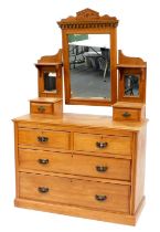 A Victorian satin walnut mirror back dressing chest, the rectangular mirror with carved frieze flank