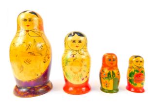 Four Russian Matryoshka nesting dolls, differing designs and sizes, the largest 26cm high.
