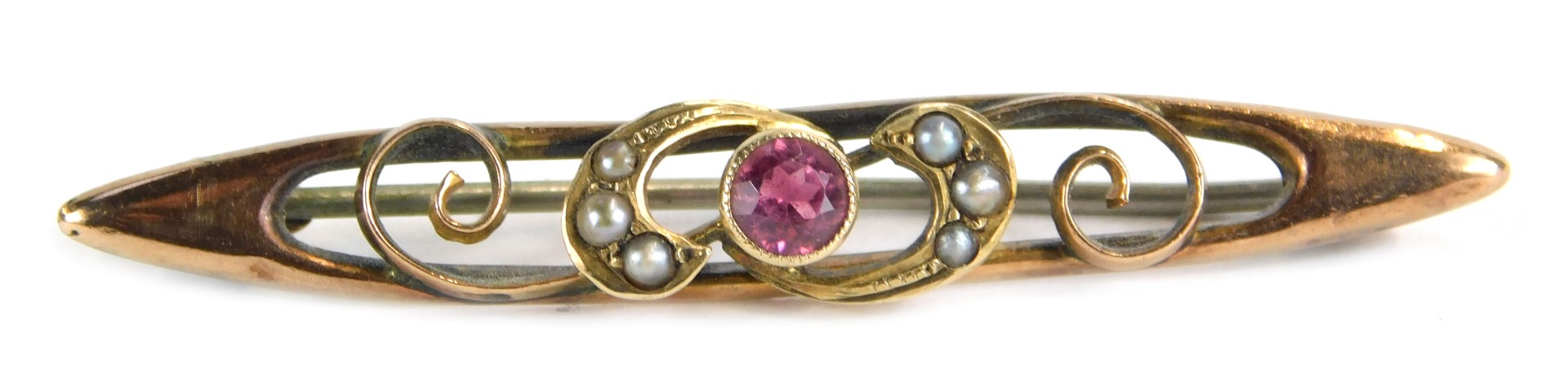 A 9ct gold topaz and seed pearl bar brooch, the central pink topaz flanked by seed pearl set scrolls
