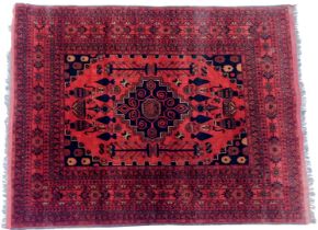 A Persian style rug, red ground, decorated with central medallion within multiple borders, 200cm x 1