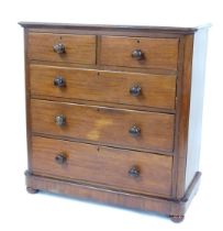 A Victorian mahogany chest, of two short over three long drawers, the top with a rounded edge, on co