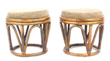 A pair of mid century bamboo framed footstools, each of circular form with a drop in seat, 42cm high