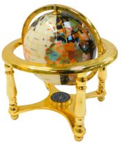 A hardstone set terrestial globe, in brass gimbal stand, the base set with a compass, 24cm high.