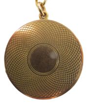 A locket pendant and chain, the circular locket of engraved design, with vacant cartouche, yellow me