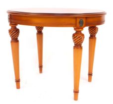 A French Empire style walnut oval table, on turned and tapered legs, 53cm high, 65cm wide, 56cm deep