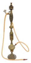 A Middle Eastern brass floor standing hookah pipe, with pierced decoration and etched floral motifs,