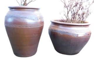 A bronze glazed garden pot, of cylindrical tapering form, with incised wave and scroll decoration, 5