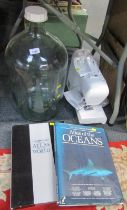 A Singer electric sewing machine, together with a glass jar and a copy of The Atlas of the Oceans. (