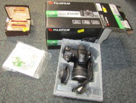 A Fuji Film digital camera, S5600, boxed, together with a Colibri atomiser and lighter set, cased.