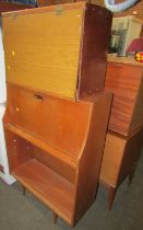 A mid century oak students bureau, with fall enclosing a fitted interior, the base with open shelves