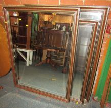 A pair of rectangular wall mirrors, each with a gold coloured and dark red frame, bevelled mirror pl