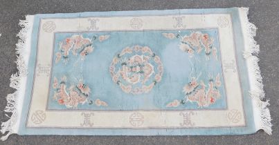 A Chinese wool cut rug, blue ground, 91cm wide.