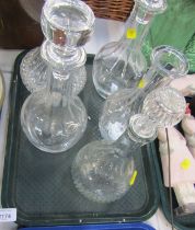 Five glass decanters, differing styles.