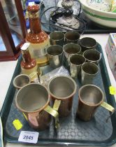 Assorted white metal gill measures, four graduated copper and brass cup measures, and two Bell's Sco