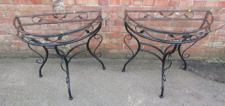 Two metal framed D end tables, each with a glass top, 63cm wide.