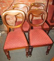 A set of four Victorian mahogany balloon back dining chairs, each with a drop in seat.