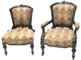 A Victorian ebonised open armchair, with a padded back, arm rests and seat, and a matching nursing c