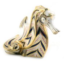 A Royal Crown Derby porcelain seahorse paperweight, lacking gold button, red back stamp.