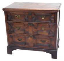 An 18thC oak chest of drawers, the top with a moulded edge above two short and two long panelled dra