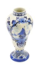 A Delft baluster shaped pottery vase, decorated with ships, etc., 20cm high. (AF)