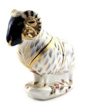 A Royal Crown Derby porcelain ram paperweight, gold button and red back stamp.