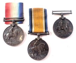 Three George V silver 1914-1918 defence medals, two with ribbons, inscribed 214510GNRW Hilton RA, an