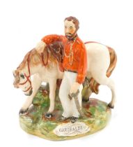 A 19thC Staffordshire pottery figure of Garibaldi beside his horse, painted in shades of red and bro