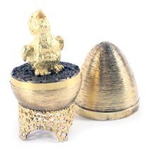 A Stuart Devlin silver parcel gilt Fledgling egg, London 1971, with unmarked silver gilt coloured st