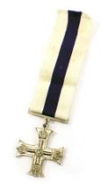 A replica base metal military cross, with modern ribbon.