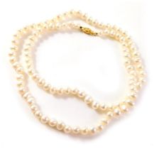 A cultured pearl necklace, the white lustre beads on a knotted string strand, with yellow metal clas