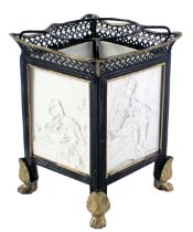 A 19thC German porcelain tea light holder, with ebonised and gilt metal mounts set with four lithoph