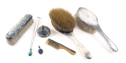 A silver backed part dressing table set, comprising a Phil Packham design hand brush, additional bru