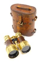 A pair of French brass and brown leather field glasses, stamped L.PETIT in an associated WWI leather