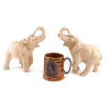 Two resin moulded elephants, 16cm high, and a Lord Nelson mug.