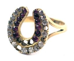 An Edwardian horseshoe ring, the two row horseshoe set with diamond and rubies, on V splayed shoulde