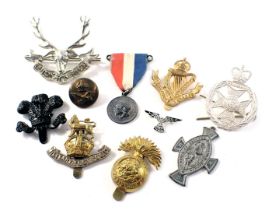 A group of cap badges and pins, for the Cognac Ranches, Military Foot Police, and others. (a quantit