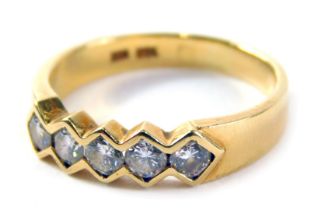 An 18ct gold diamond five stone dress ring, set with five round brilliant cut diamonds, each in a te