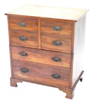 A George III mahogany commode, the hinged cross banded ebony and boxwood strung lid enclosing a rece