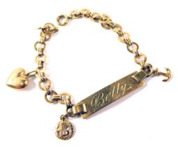 An identity bracelet, inscribed Betty M Asmara 1954, with curb link, and three charms yellow metal s