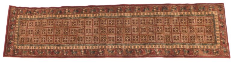 A Belgian cotton Persian style runner, with a design of roundels within squares on a red ground, ret