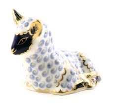A Royal Crown Derby porcelain lamb paperweight, gold button and red back stamp, also signed Julie To