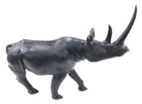 A large African carved stone model of a rhino, 74cm long.