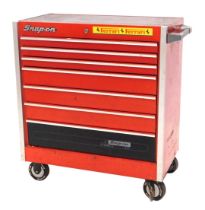 A Snap-On portable tool chest, painted in red with side handle and castors, 87cm wide.