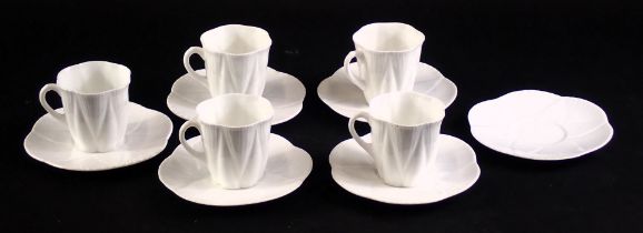 A Shelley white glazed part coffee set, comprising five cups, six saucers, each with stylised shell